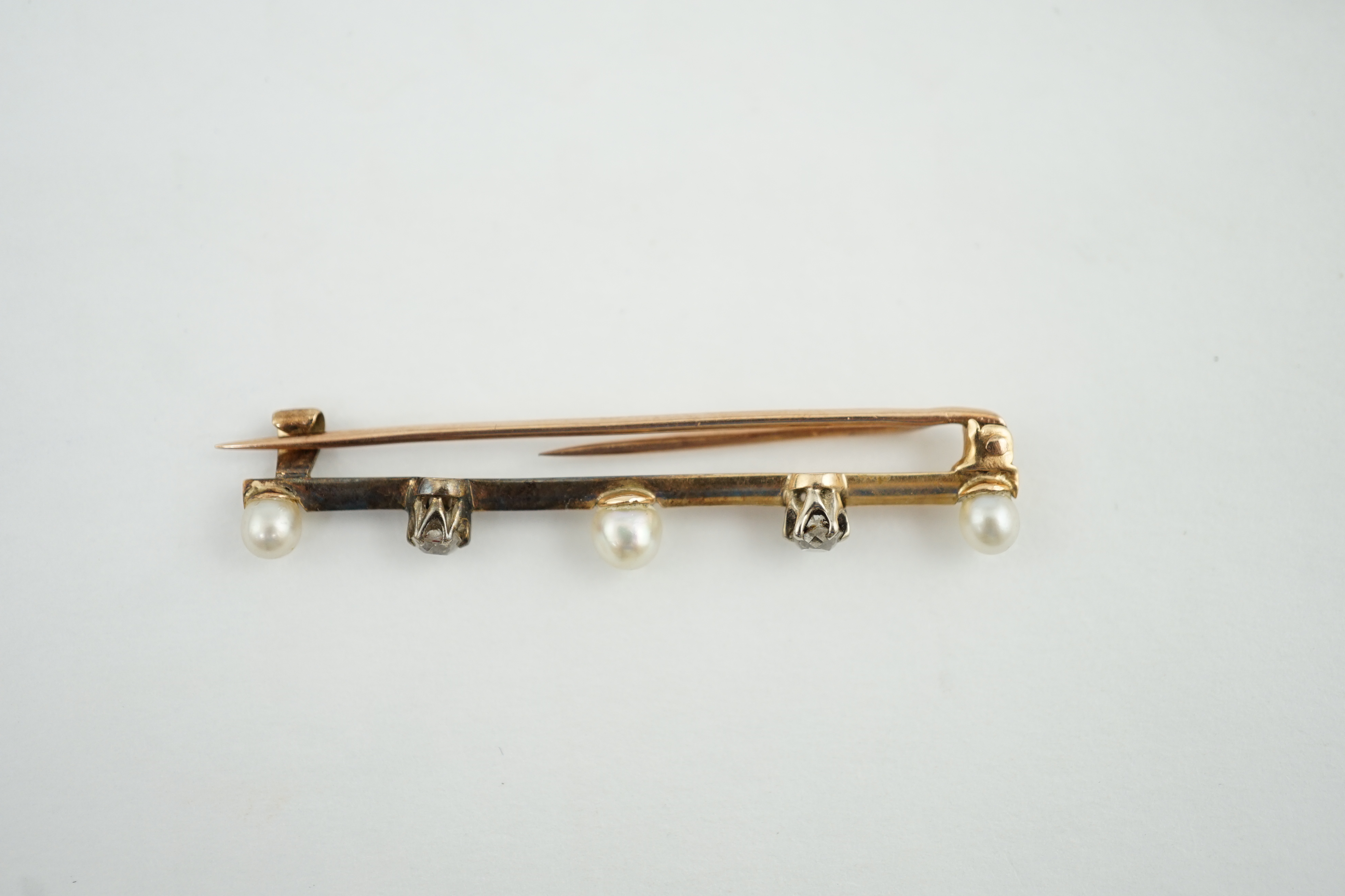 An Edwardian gold, pearl and diamond bar brooch